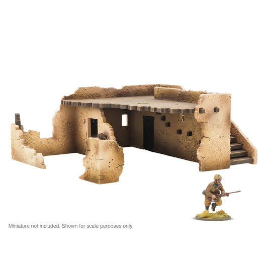 Warlord Games Adobe Building SLC0035 – zniszczony budynek adobe z widoczną częścią schodów, wnętrze parteru i figurka żołnierza, teren do Bolt Action