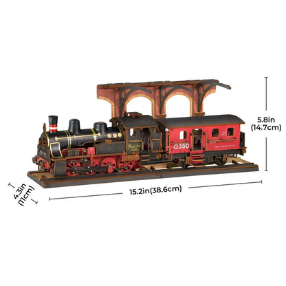 Parowóz Steam Journey Rolife TGS01 – składanie modelu: ręka umieszczająca wagon na drewnianych panelach podstawy