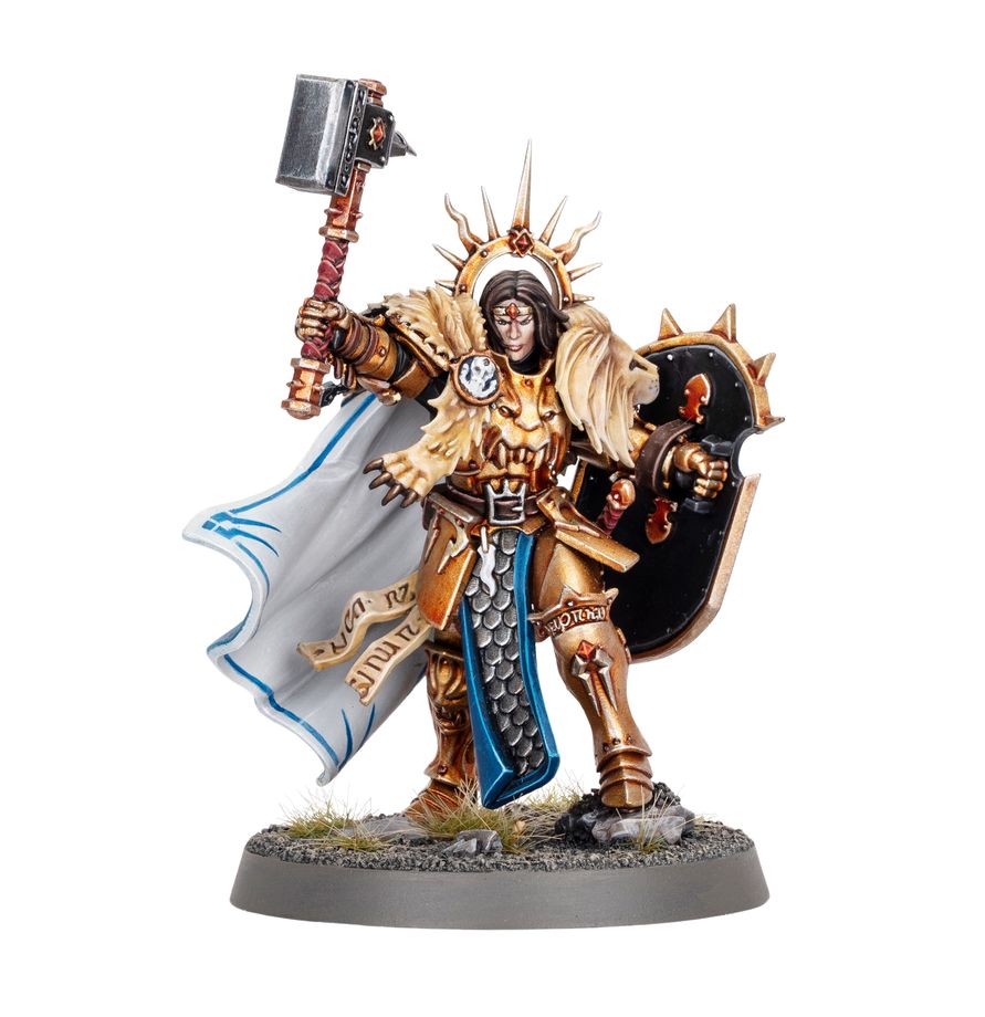 Lord-Celestant - złoty pancerz twarz z czerwonym znakiem futrzana peleryna lwa czarna tarcza z kolcami i młot Stormcast Eternals
