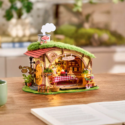 Leśna Chatka Fluffy Grove Rolife DG184 – składanie modelu: ręce trzymające miniaturową figurkę zajączka na tle gotowego modelu