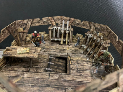 Watchtower BSTFWE008 28-35mm Battle Systems - wnętrze górnego piętra stojaki na broń miecze figurki walczące widok z góry ciemne tło
