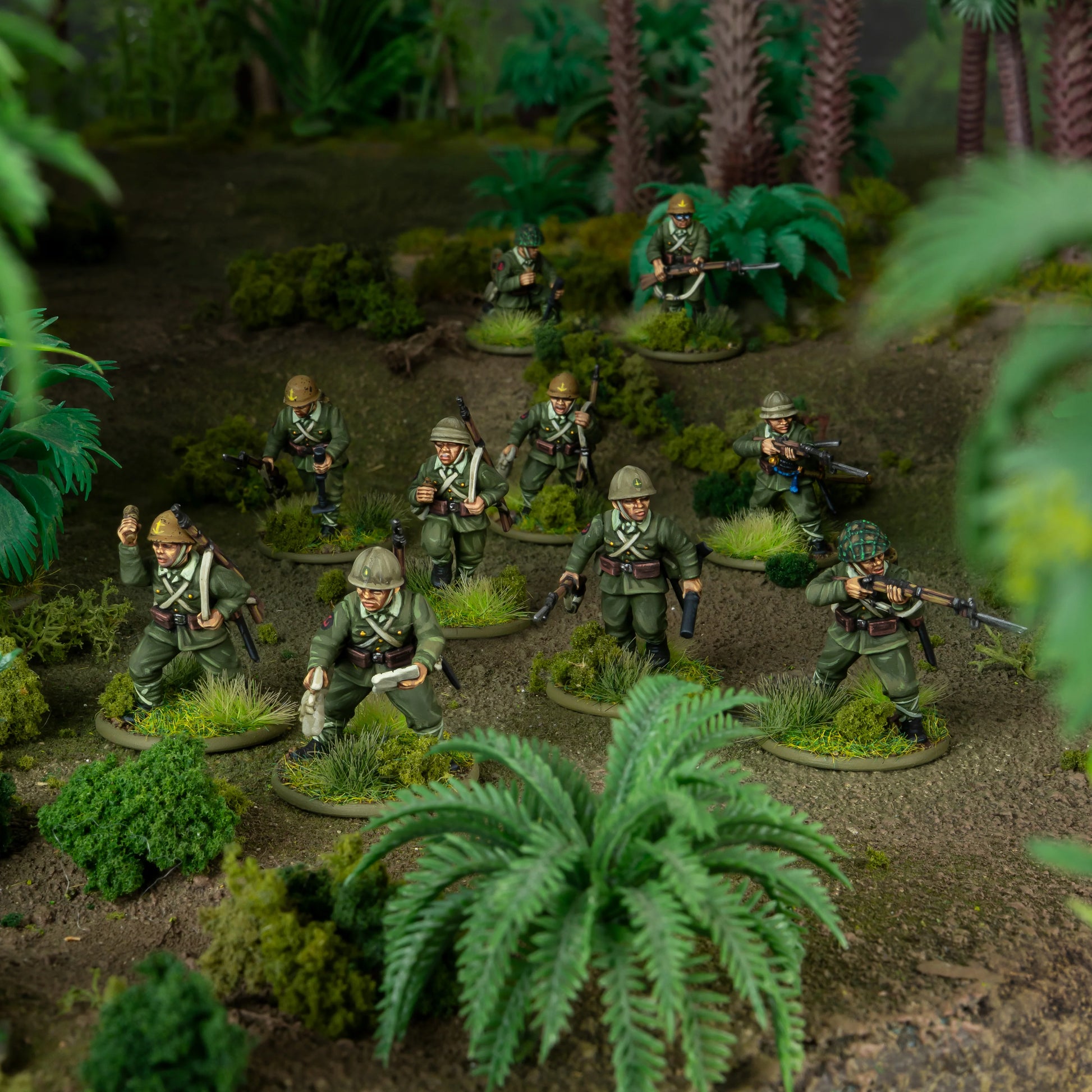 Japanese Army Infantry Platoon – 9 figurek IJA na dioramie dżunglowej: oficer z pistoletem, grenadier z granatem, strzelcy z Arisaka i bagnetem, hełmy khaki, tropikalna roślinność, skala 28mm
