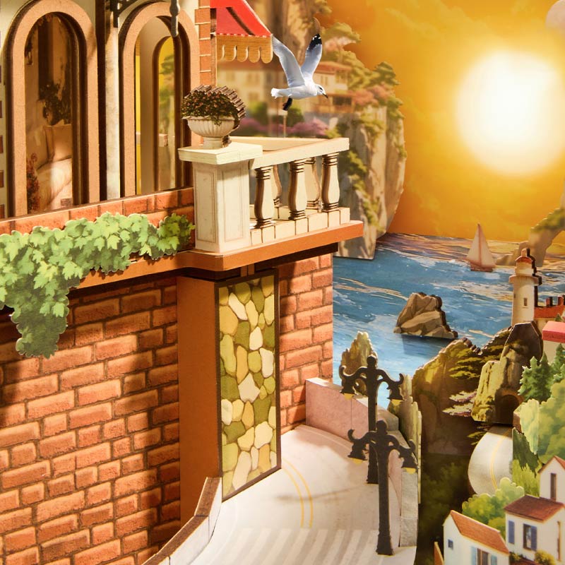 Sunset Isle Rolife TGB18 – składanie modelu: ręce trzymające miniaturowy fotel ze śpiącym kotem i drewnianą podstawką