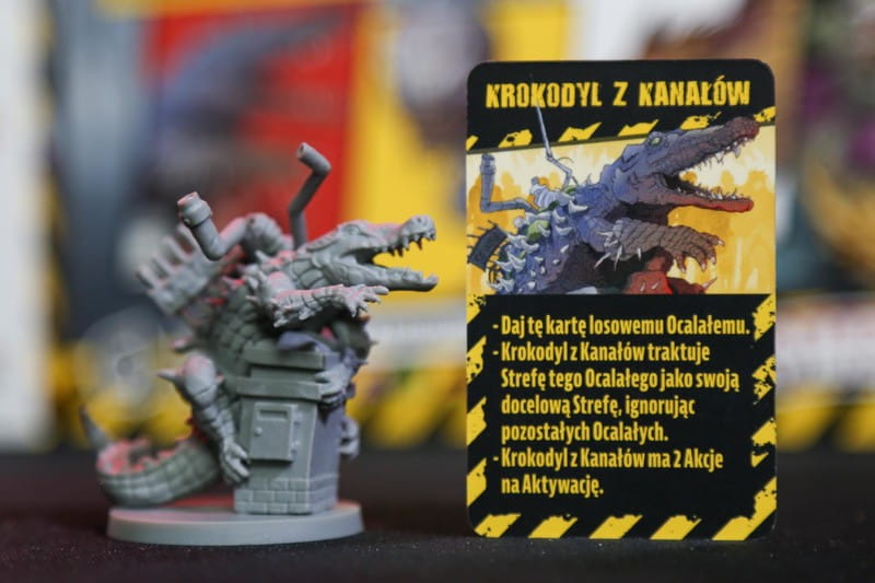 Zombicide Miejskie Legendy – figurka i karta Porywacza: ignoruje Strefy Mroku i porywa Ocalałych
